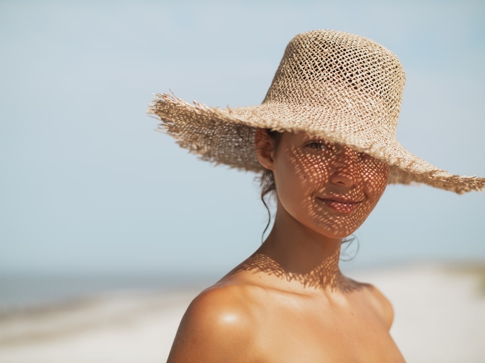 Beach,Woman,In,Sun,Hat,On,Vacation