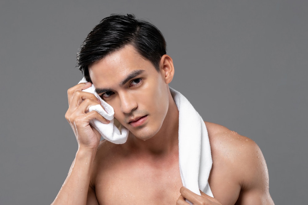 Young,Handsome,Shirtless,Southeast,Asian,Man,Wiping,His,Face,With