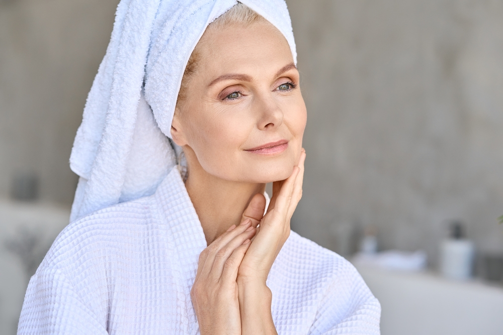 Happy,Beautiful,Middle,Aged,Woman,Wearing,Bathrobe,And,White,Towel